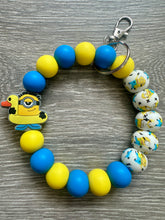 Load image into Gallery viewer, Coming to Theaters- Minion wristlet keychain
